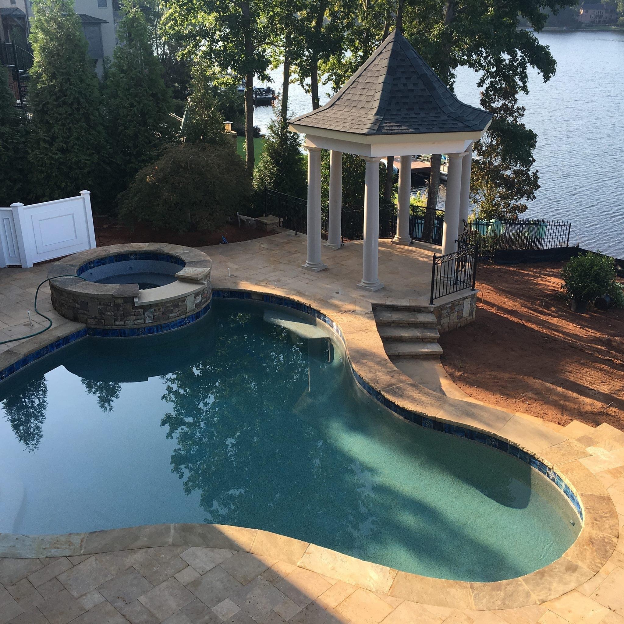 Outdoor pool and backyard retreat by Tri-State Pools